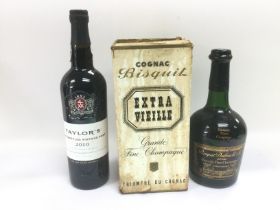 A boxed bottle of Bisquit cognac and a 750ml bottle of 2010 Taylor's port (2). Shipping category D.