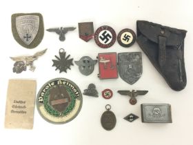 A collection of reproduction Third Reich pins, badges etc including a leather holster and an SS