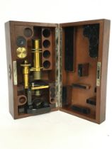 Cased Wray London microscope with a brass body. Postage category C