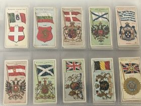 An album containing a well presented collection of Players cigarette cards including 1905 Flags