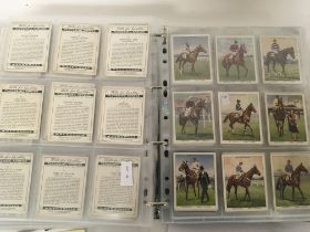 An album containing a well presented collection of Wills Cigarette cards including large cards. NO