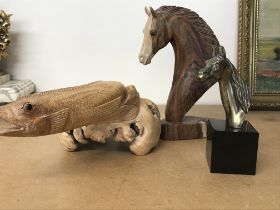 A small bronze horse head a carved horse head and