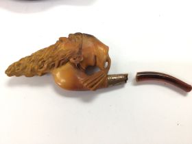 A carved pipe with case. Damaged. Postage B