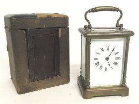 A cased French 8 Day Brass Carriage clock, with turned side pillars and bevel glass encasing.