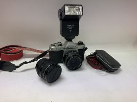 A box of cameras and camera equipment, including two Pentax K1000sand a asahi Pentax 52mm lens along