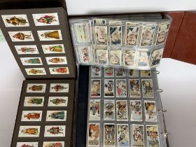 A large collection of varied cigarette cards.