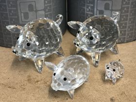 Four boxed Swarovski pigs. No Obvious damage or restoration