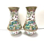 A pair of Cantonese porcelain baluster shaped vases. 25cm (D) some damage to rim.