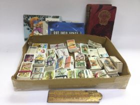 A box of tea cards, some loose and some in albums plus a 1901 Country Pastimes For Boys book,