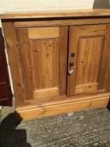 An Antique pine cupboard the rectangular top above a pair of doors on a plinth base- NO RESERVE