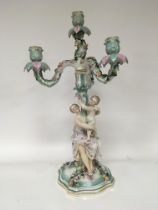 A German porcelain candelabra possible Sitzendourf the stem with a lady a child with raised