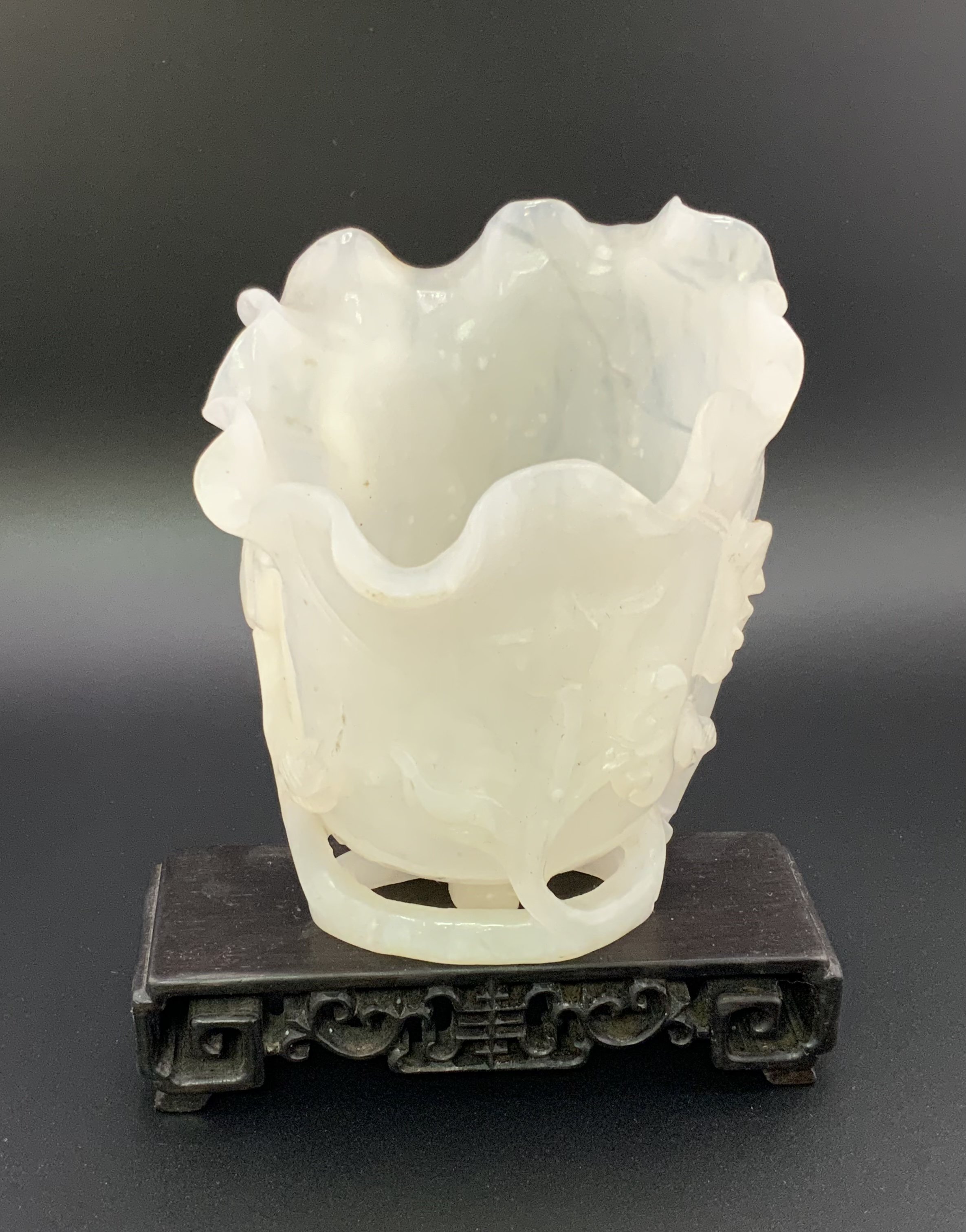A Chinese carved white jade vase In furled lotus l