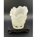A Chinese carved white jade vase In furled lotus l