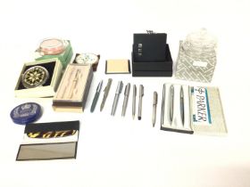 A collection of various pens and compacts and powder bowls. Including a hip flask. Postage D