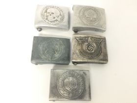 A collection of German WW2 belt buckles including Front Heir Skull Belt Buckle, Waffen-SS Belt