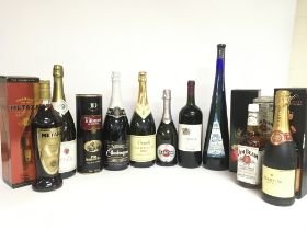 A collection of various spirits and wines including Martini Brut, Jim Bean Bourbon Whiskey, Pinot