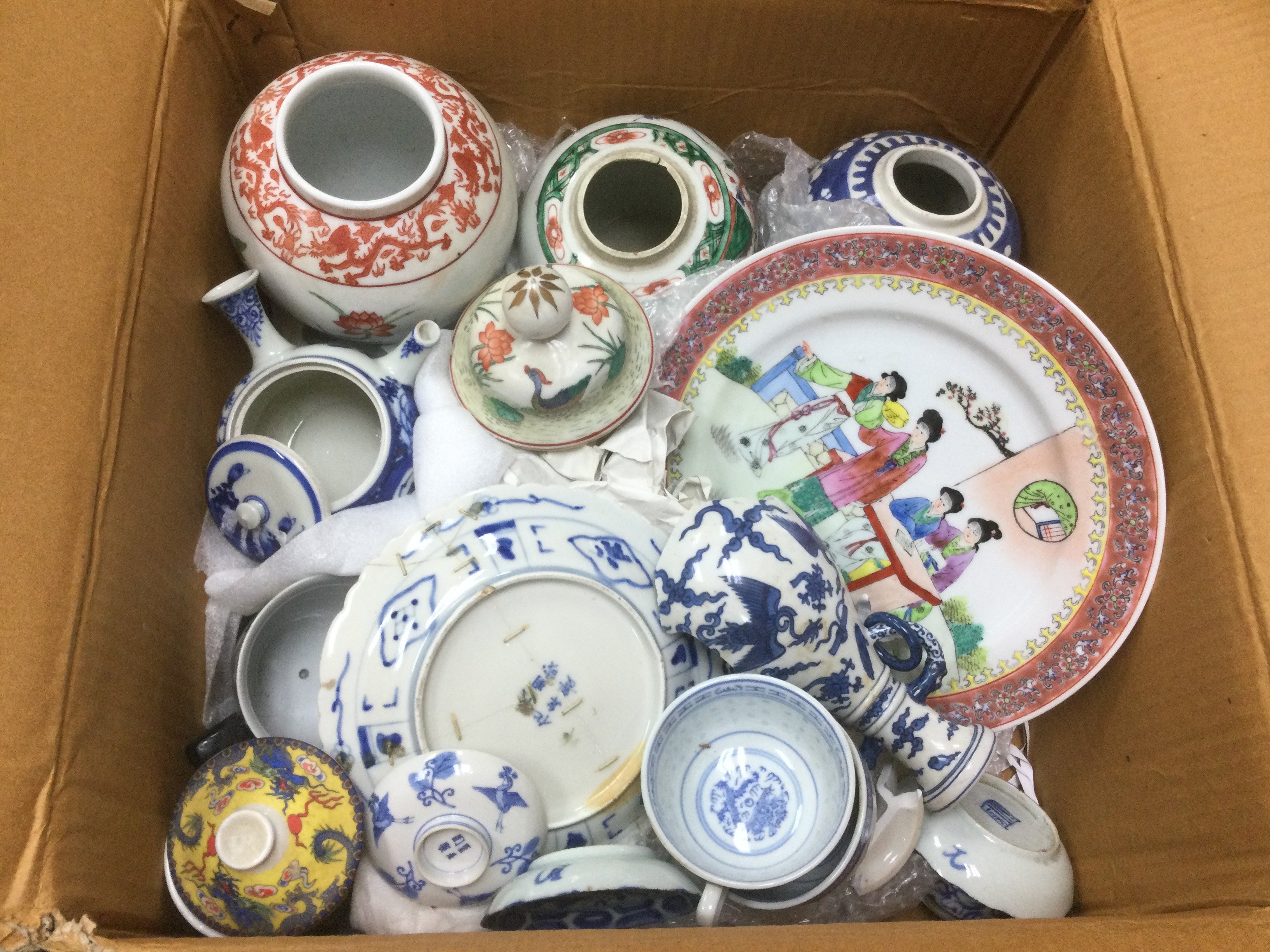 A box of Oriental ceramics comprising a blue and white ginger jar, vases, plates etc. Shipping