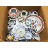 A box of Oriental ceramics comprising a blue and white ginger jar, vases, plates etc. Shipping