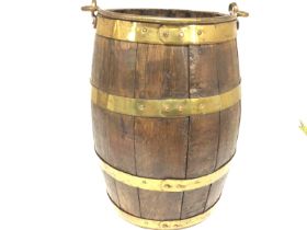 An oak barrel with brass mounts. 37x 24cm Postage C