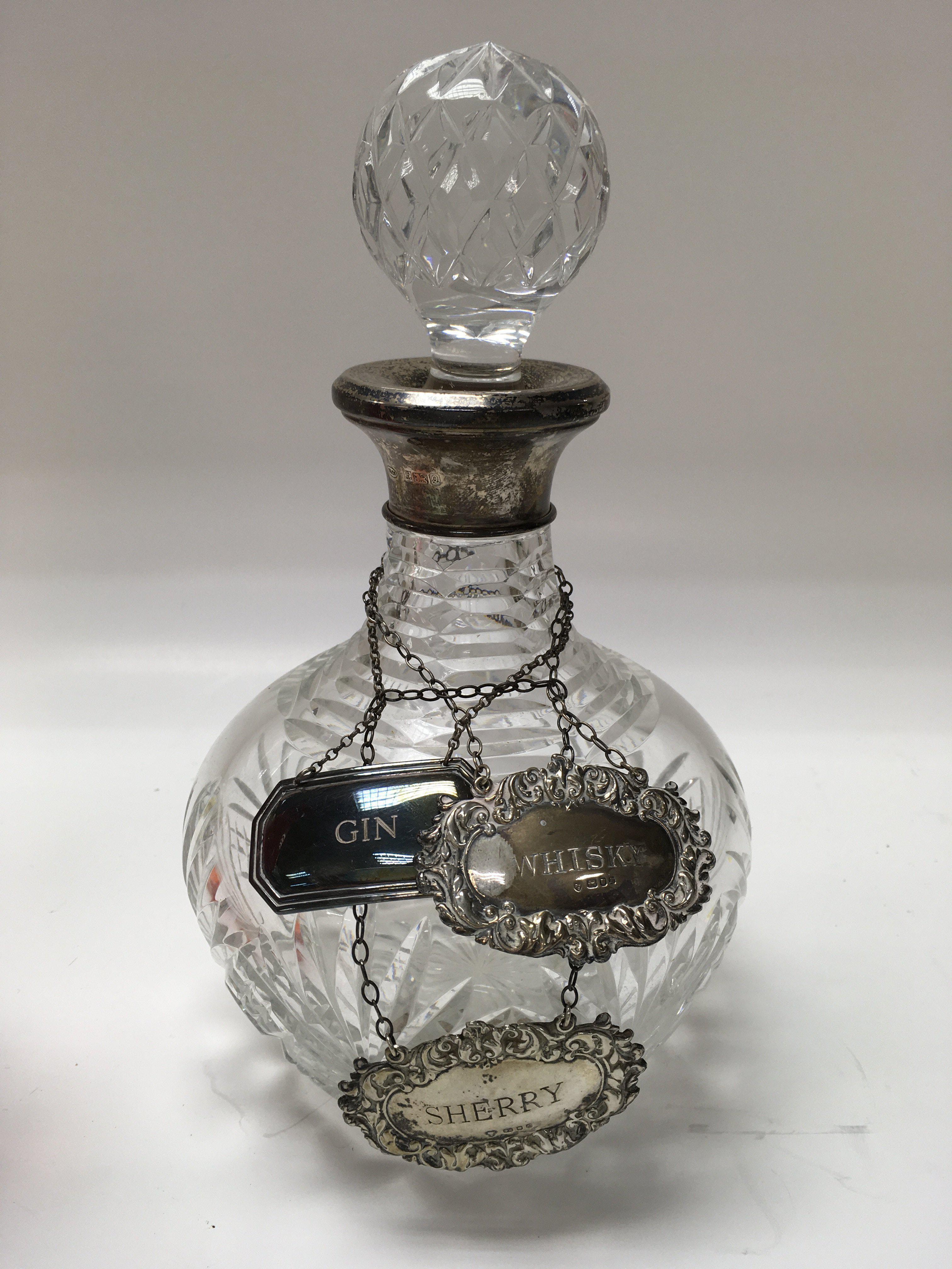 A cut glass and silver mounted decanter with silve