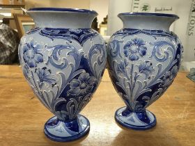 A pair of Florian ware Macintyre ashes with floral tube lined decoration. 22 cm in height. No