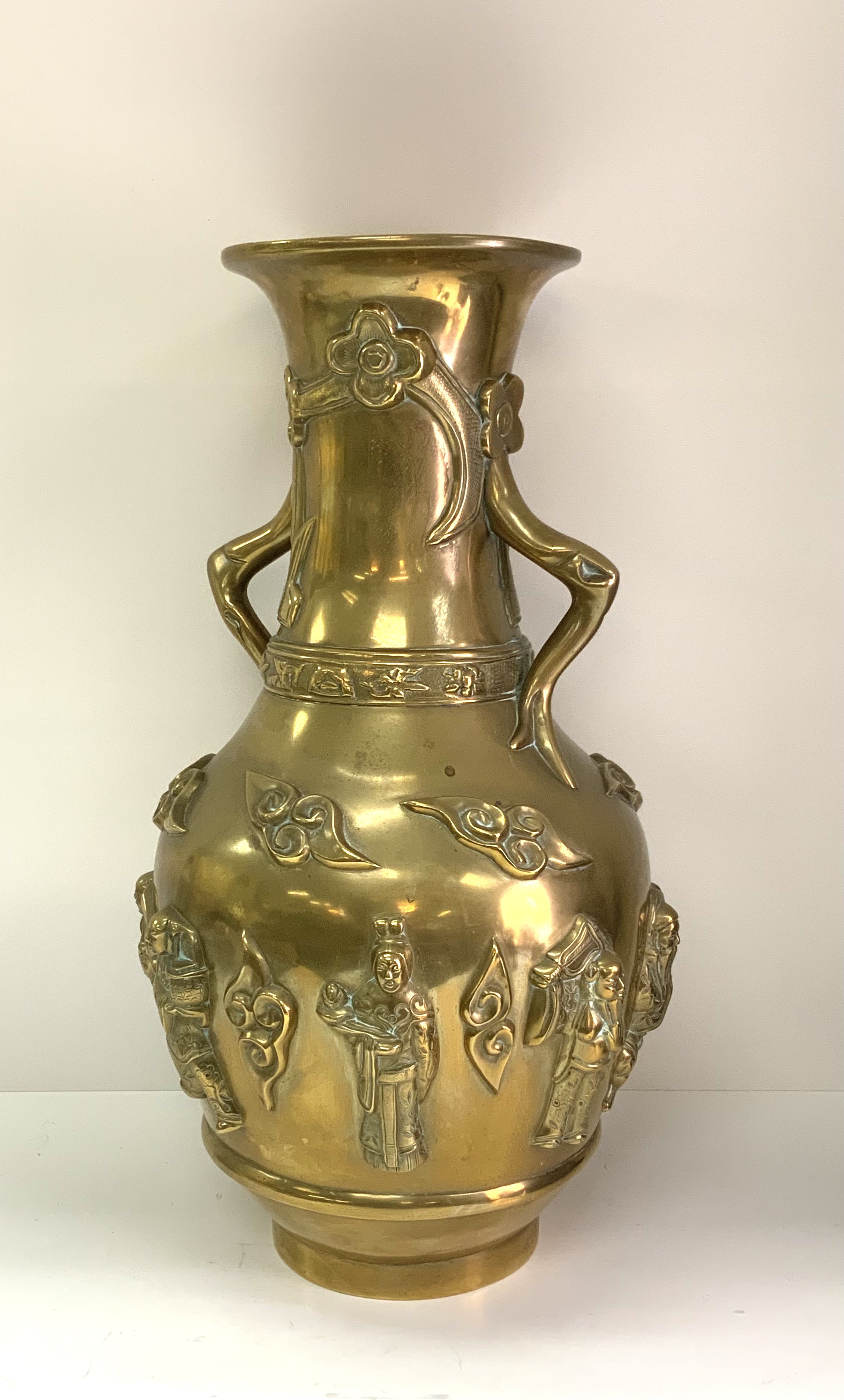 A 19th century Chinese cast bronze vase surrounded by 8 images of immortals. 39cm.