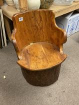 A small tub style log chair.