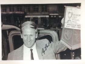 A Bobby Charlton signed photo approx 29cm x 20cm. Shipping category A. NO RESERVE