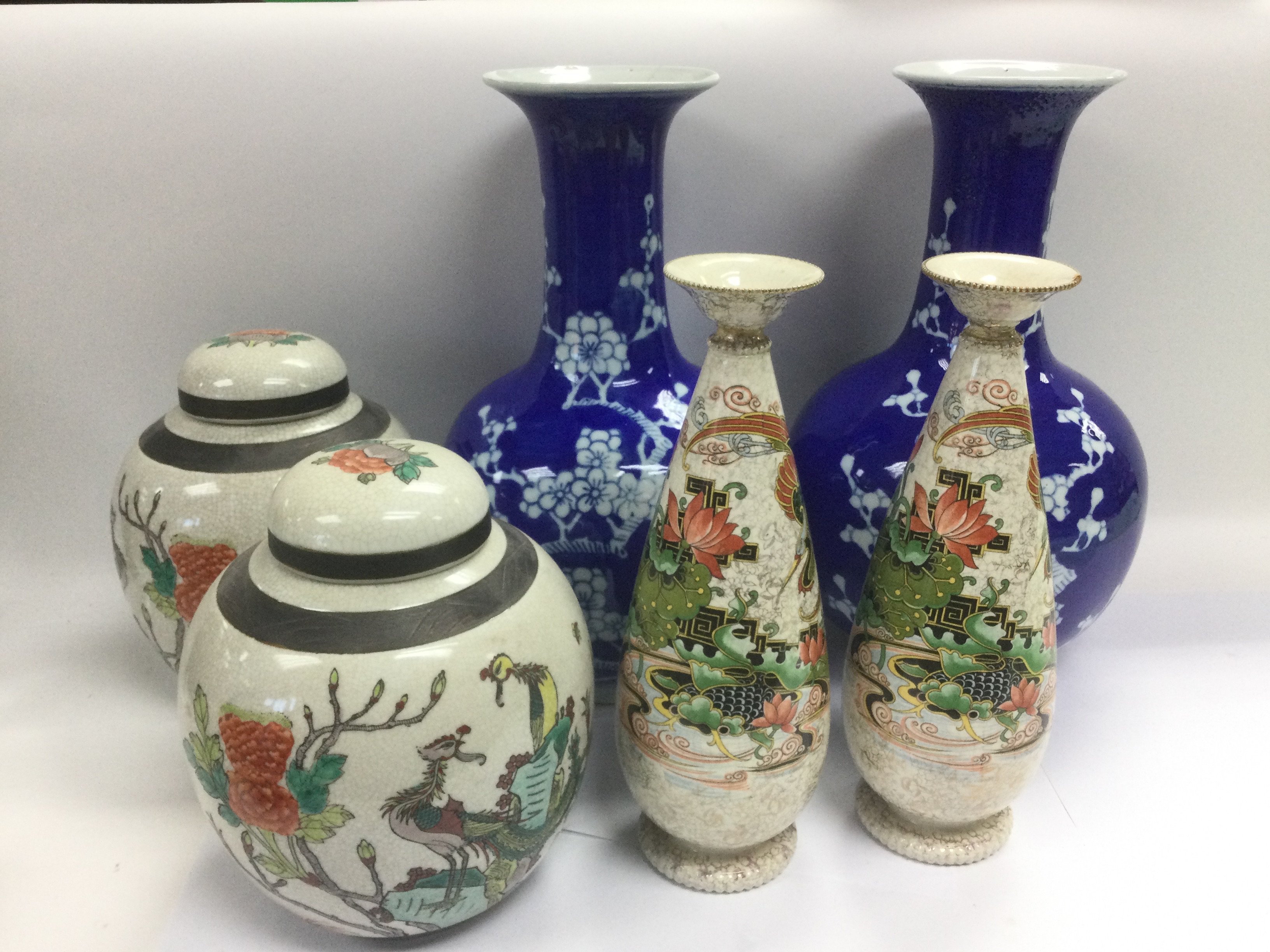 Three pairs of Oriental style vases comprising a pair of blue and white vases decorated with