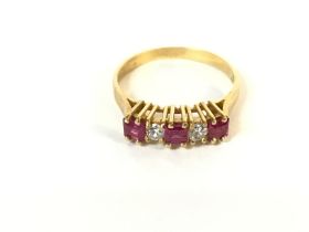 An 18ct gold diamond and ruby ring. Size P 1/2 and