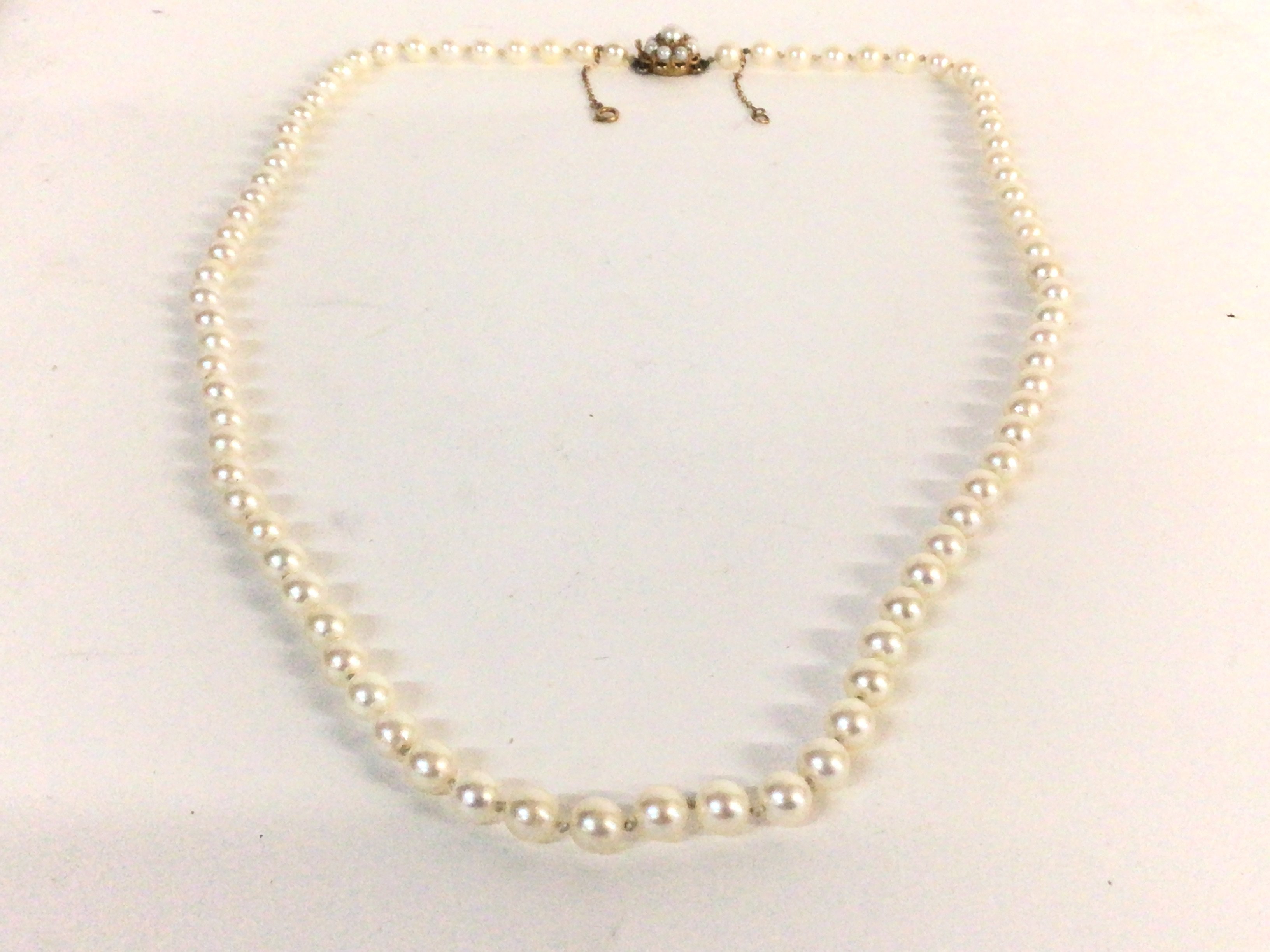 A string of cultured pearls with a 9ct gold clasp