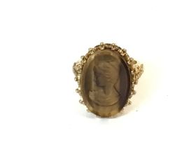 A 9ct gold tiger eye carved cameo ring. Size I and