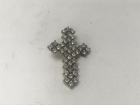 A 9ct gold diamond set cross. Approx 1.5ct, weight