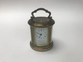 Matthew Norman London small oval carriage clock. A