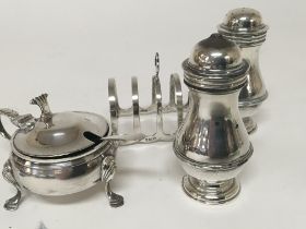 A silver toast rack silver mustard pot and condime