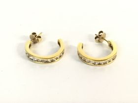 A pair of 18ct gold earrings set with diamonds. Ap