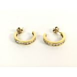 A pair of 18ct gold earrings set with diamonds. Ap