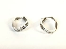 A pair of 9ct white gold modern style earrings. Ap