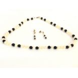A Milkimoto black pearl necklace with conforming d
