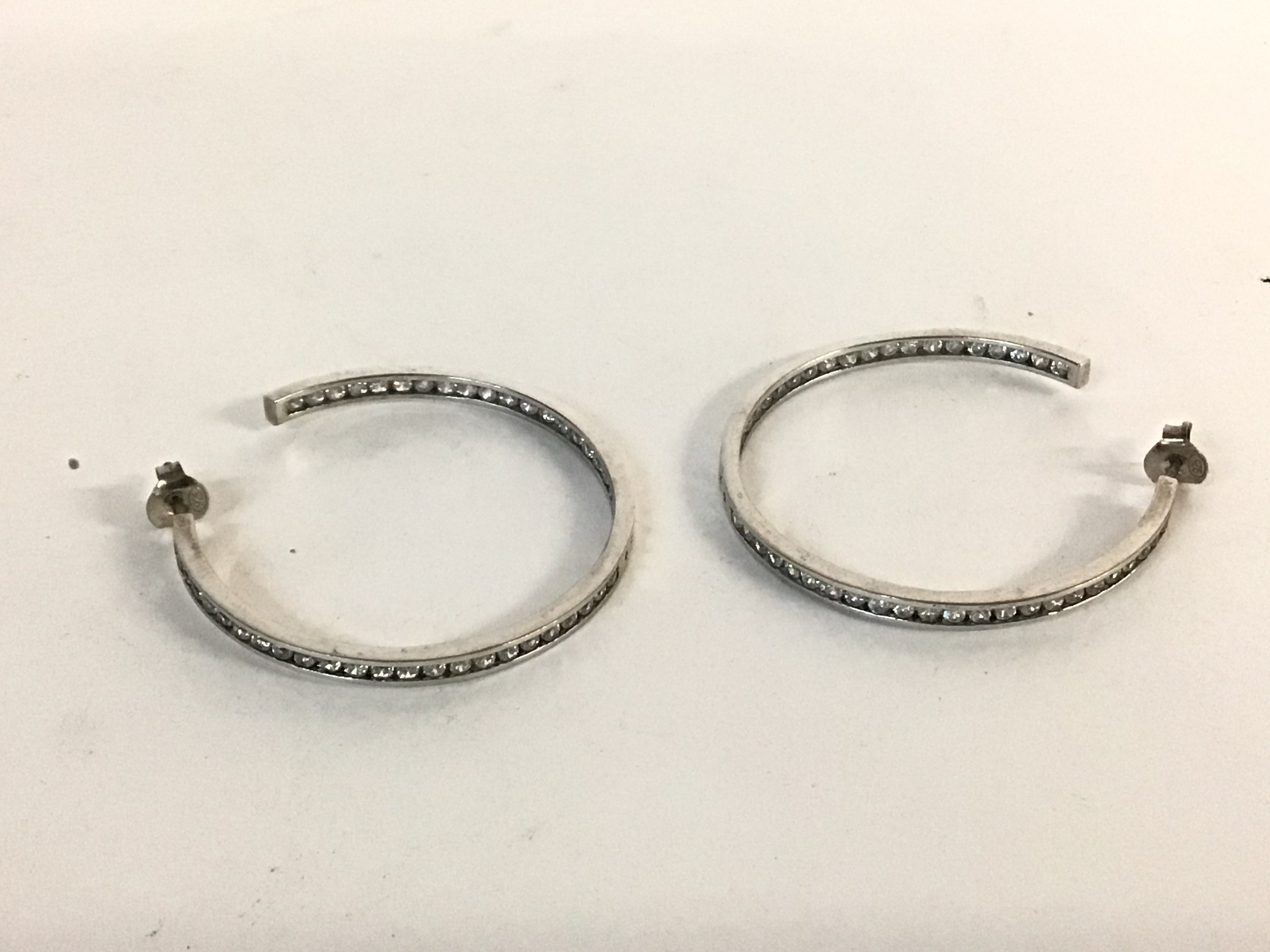 A pair of silver hoop earrings set with white ston - Image 2 of 2