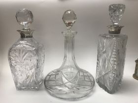 Three ship decanters two switch silver tops.