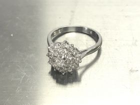 An 18ct diamond cluster ring, approx 1ct and weigh