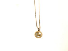 A 9ct gold chain with a 9ct gold Aries Zodiac pend