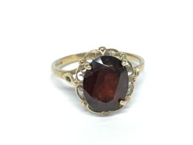 A 9ct gold garnet ring , 2.13g size M. Postage cat