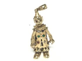 A 9ct stone set clown charm pendant, 19.6g. (Some