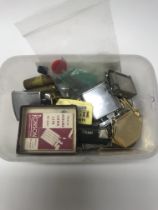 A box of old lighters with flints and spares.