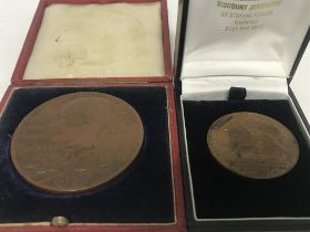 Two medallion coins, including the British Empire