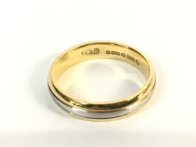 An 18ct gold and platinum ring. 4.64g and size M P