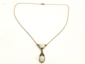 A 9k gold necklace set with two opals. 50cm long a