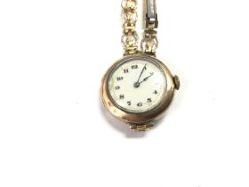 A vintage ladies 9ct gold watch with enamel face.